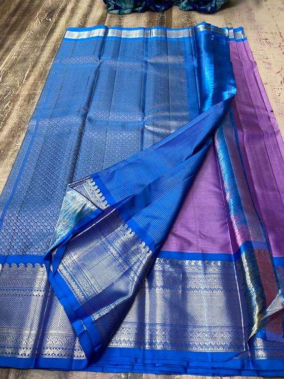 Lavender silk saree with royal blue zari brocade pallu and border